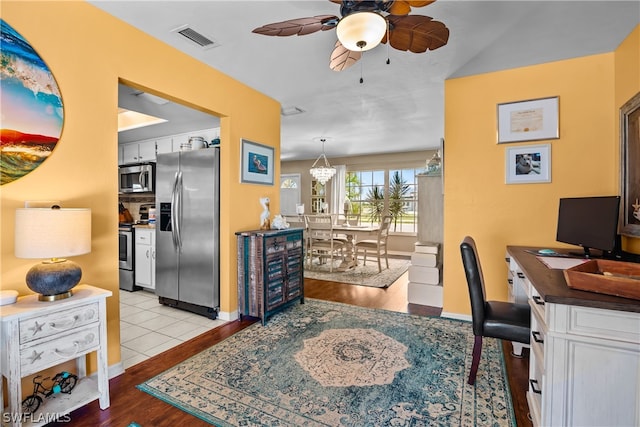 office space featuring ceiling fan and light hardwood / wood-style floors