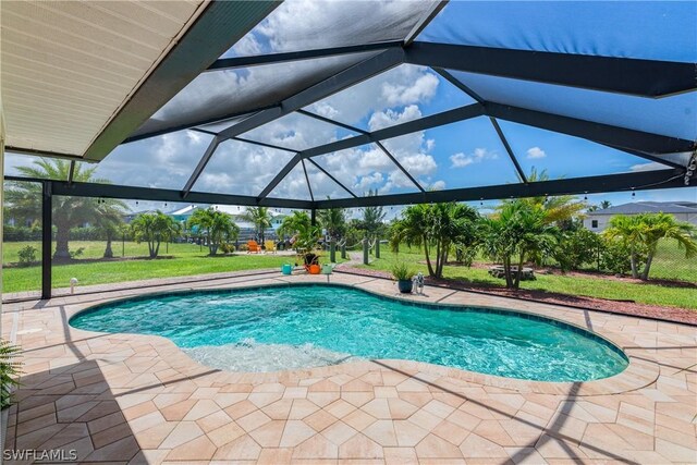 view of pool with a patio, a yard, and a lanai