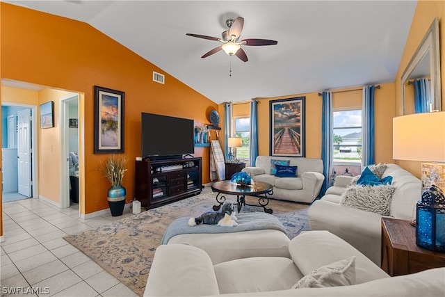 living room featuring light tile patterned flooring, ceiling fan, and vaulted ceiling