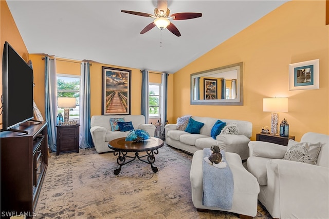 living room featuring vaulted ceiling, ceiling fan, and a wealth of natural light