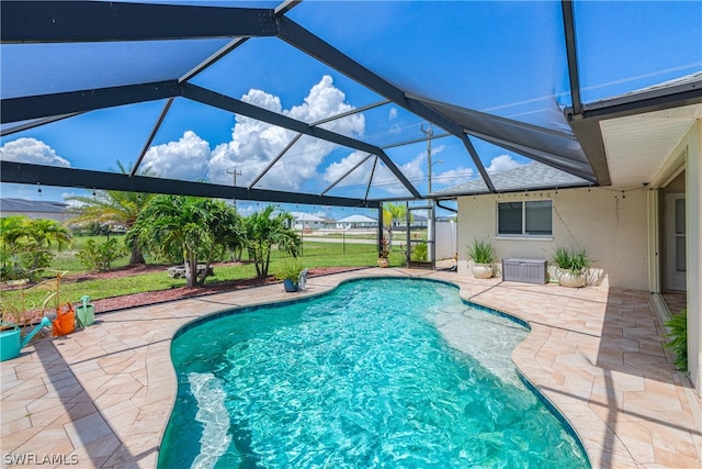 view of swimming pool with a lanai and a patio area