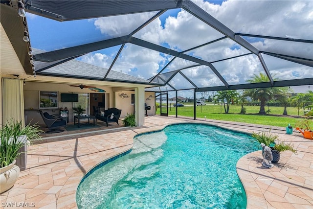 view of pool with a lawn, a patio, a lanai, and ceiling fan