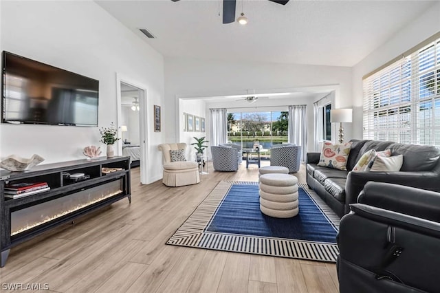 living room with ceiling fan and light wood-type flooring