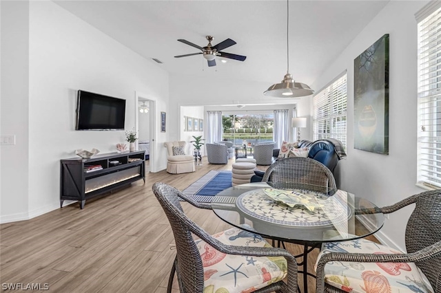 dining area with wood-type flooring and ceiling fan