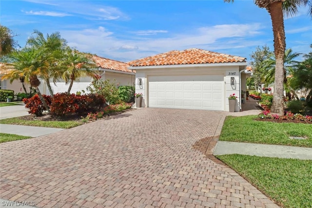 mediterranean / spanish house with a garage