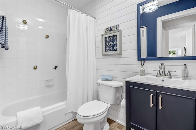 full bathroom with hardwood / wood-style flooring, shower / tub combo, toilet, and vanity