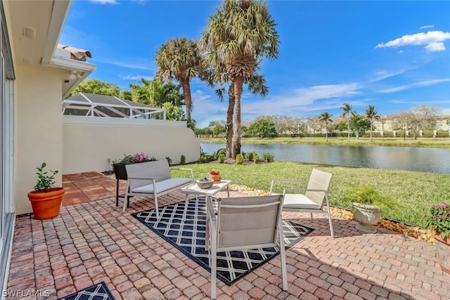 view of terrace featuring a water view and a lanai