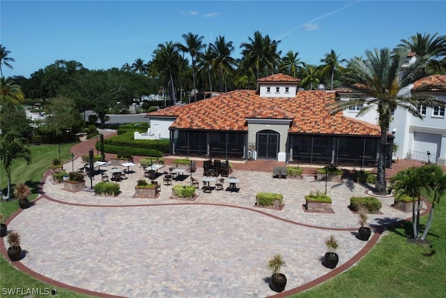 view of front of property with a garage and a sunroom