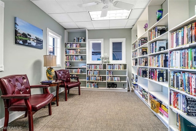 sitting room featuring a paneled ceiling and carpet flooring