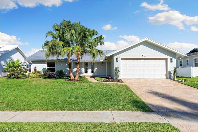 view of front of home with a garage and a front yard