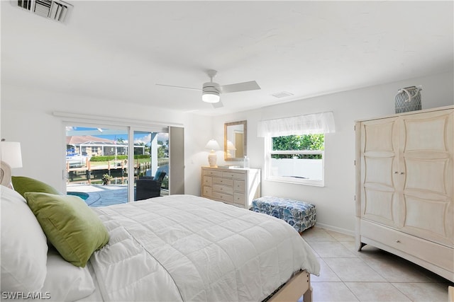 bedroom featuring multiple windows, ceiling fan, access to exterior, and light tile floors