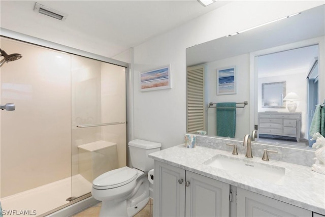 bathroom featuring toilet, a stall shower, visible vents, and vanity