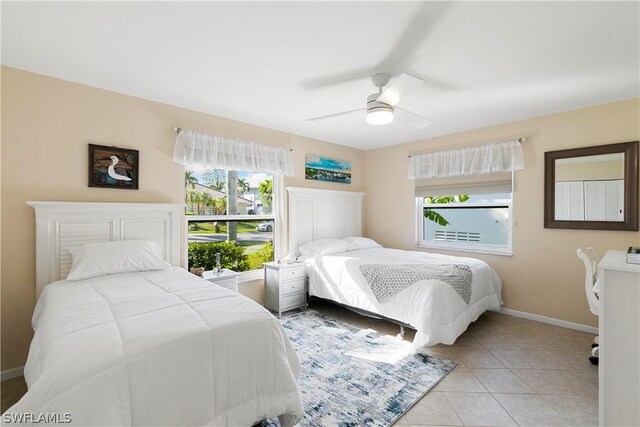 tiled bedroom featuring ceiling fan