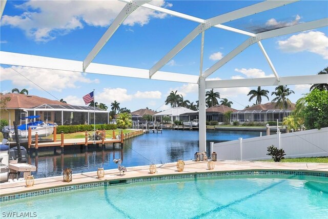 view of swimming pool with a lanai and a dock