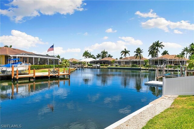 dock area featuring a water view and glass enclosure