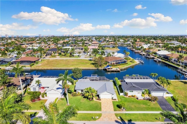 drone / aerial view featuring a water view and a residential view