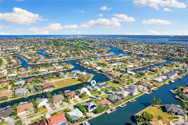 drone / aerial view with a water view and a residential view