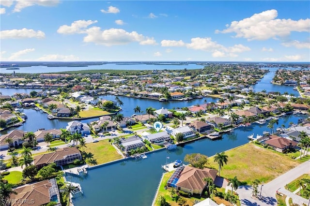 birds eye view of property featuring a water view and a residential view