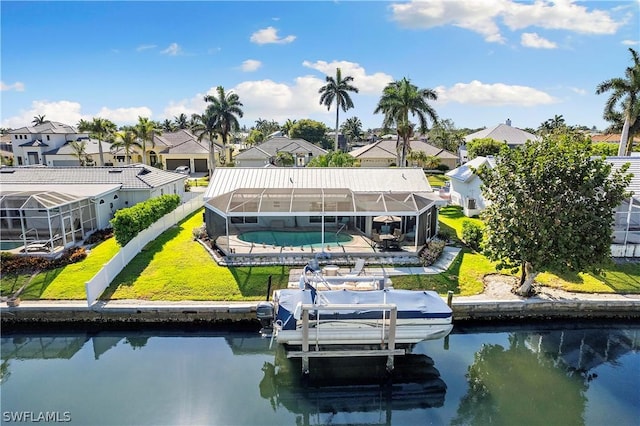 view of dock with a water view, glass enclosure, a residential view, and a lawn