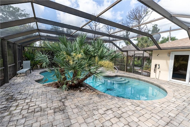 view of pool featuring a lanai and a patio