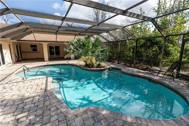 view of swimming pool with a lanai and a patio area