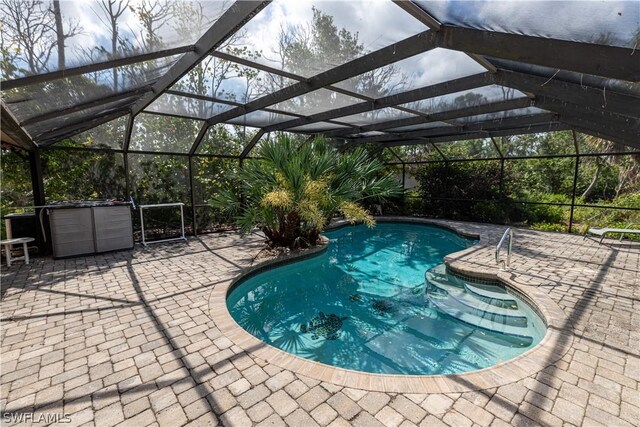 view of pool featuring a lanai and a patio