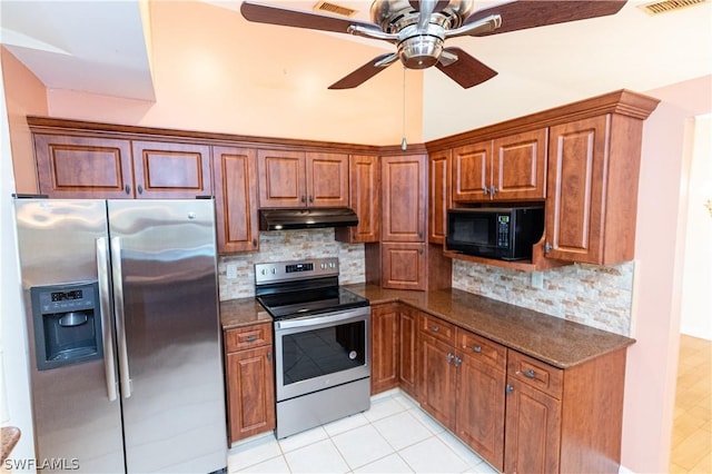 kitchen featuring backsplash, ceiling fan, dark stone counters, and stainless steel appliances