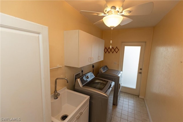 laundry room featuring cabinets, ceiling fan, sink, washer and dryer, and light tile patterned floors