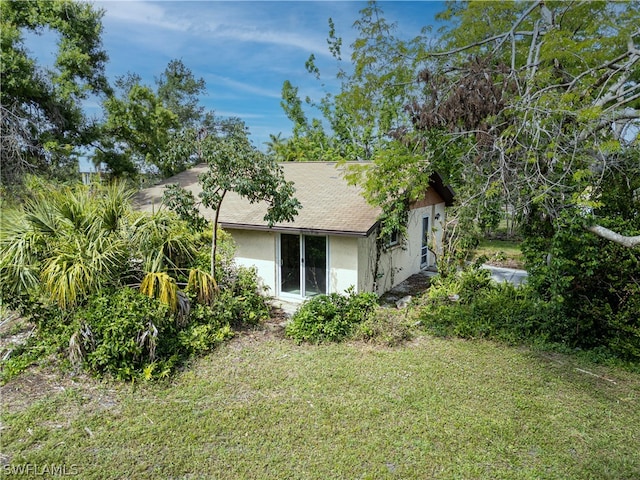 view of side of home with a lawn