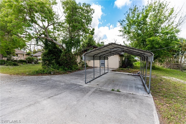 view of car parking featuring a lawn and a carport