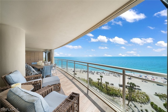 balcony with a water view and a beach view