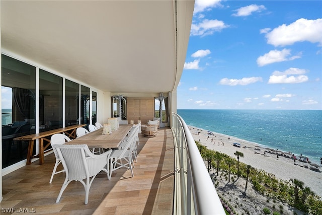 balcony with a water view and a beach view