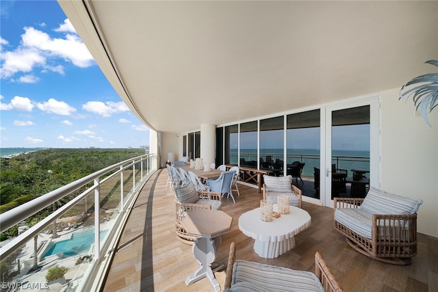 balcony with outdoor lounge area and a water view