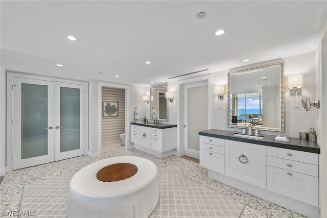 bathroom featuring french doors, a bidet, and double sink vanity