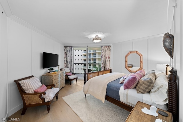 bedroom featuring hardwood / wood-style flooring and crown molding