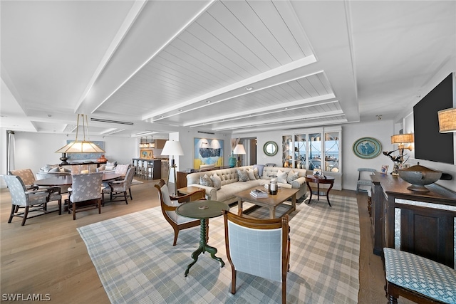 living room featuring light hardwood / wood-style floors and beamed ceiling