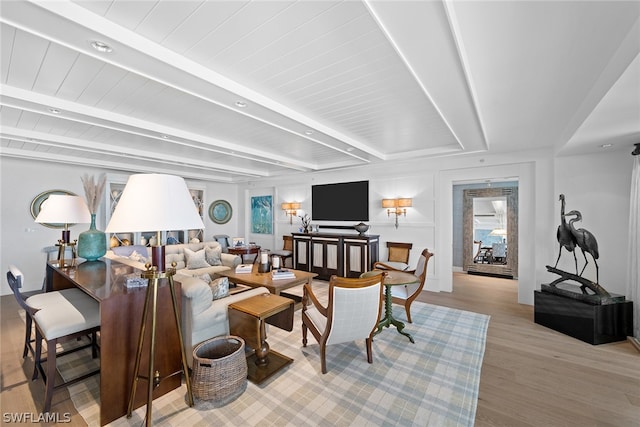 living room with beam ceiling and light wood-type flooring