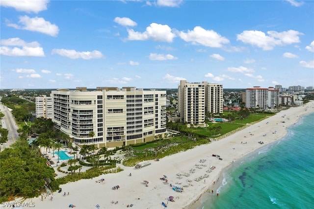 view of property with a water view and a view of the beach