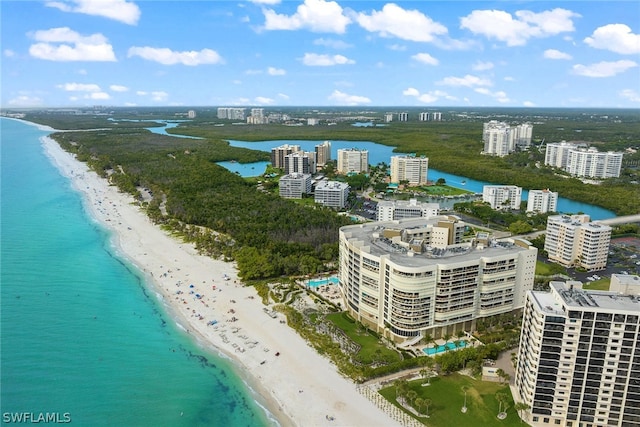 birds eye view of property featuring a beach view and a water view