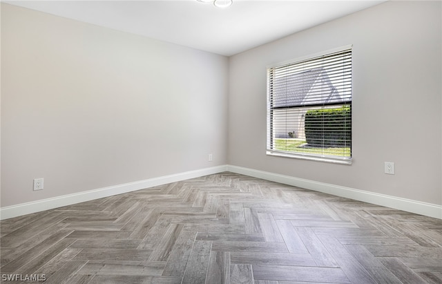 unfurnished room featuring parquet flooring