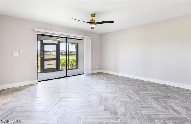 spare room featuring ceiling fan and parquet floors