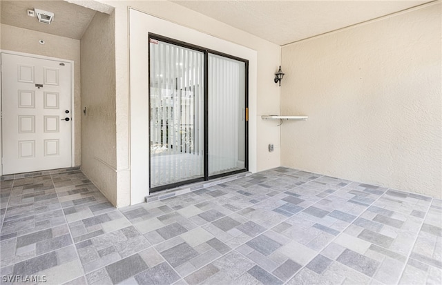 entrance to property featuring a patio area