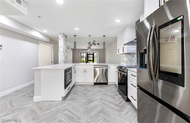 kitchen featuring kitchen peninsula, stainless steel appliances, tasteful backsplash, light parquet flooring, and pendant lighting