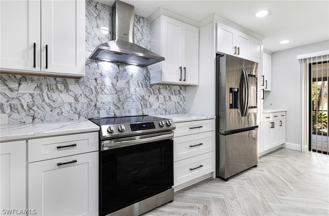 kitchen with light parquet flooring, appliances with stainless steel finishes, wall chimney range hood, and tasteful backsplash