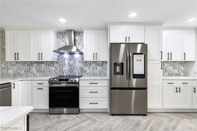 kitchen featuring appliances with stainless steel finishes, light parquet floors, wall chimney range hood, and tasteful backsplash