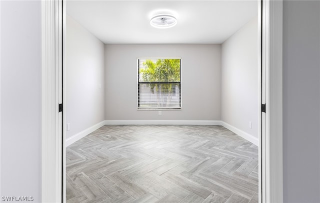 unfurnished room with light parquet flooring