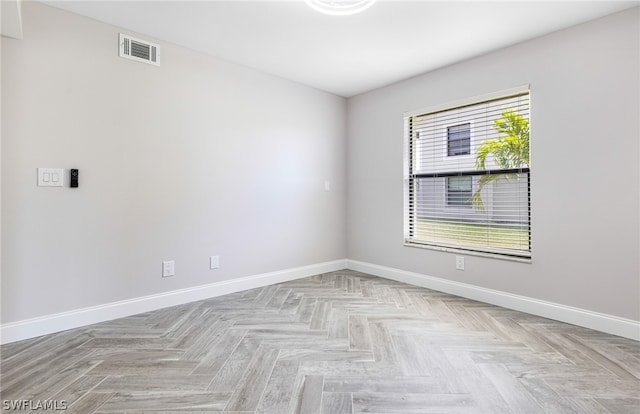 unfurnished room featuring light parquet flooring