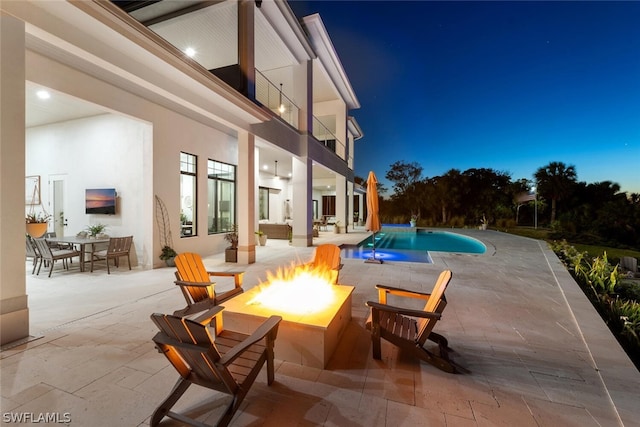 view of swimming pool featuring a fire pit and a patio area