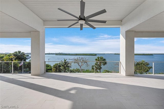 view of patio with a water view and ceiling fan