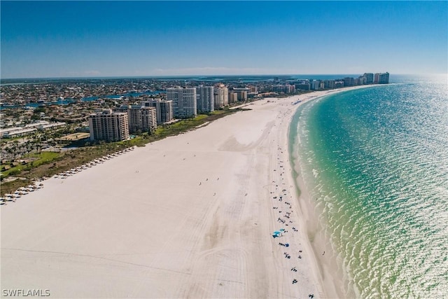 drone / aerial view with a water view and a beach view